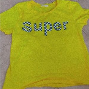 Yellow shirt with checkered print letters.